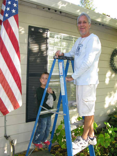 son with grampa installing lights